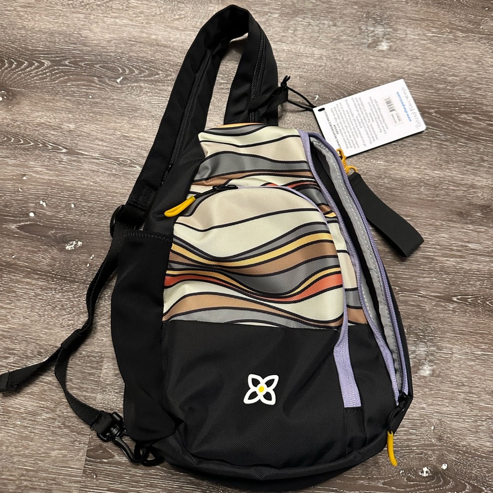 Sherpani Wayfarer Multicolor Wave Sling Backpack with Cream and Purple Accents